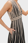 Model wearing Noir Palermo Dress with classic V-neck, vertical rickrack stripes, fitted waist, side pocket. Effortless, high-end style for fun, confident look.