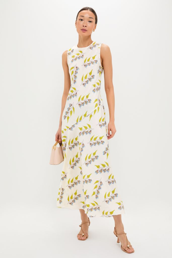 Model in the classic Infinite Flower Gaea Dress, featuring effortless botanical prints, paired with a fun pink handbag and high-end nude sandals.