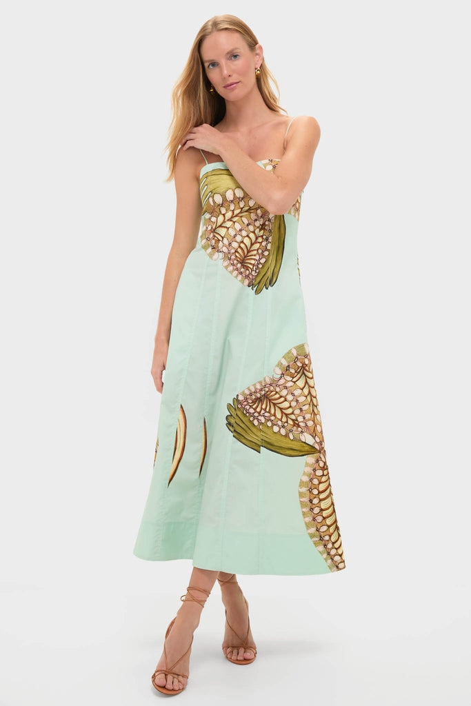Model wearing the classic Water Blossoms Vesela Dress, an effortless sundress with abstract motifs, paired with strappy sandals, reflecting high-end, fun style.