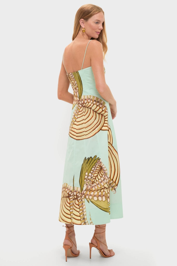 Model wearing the Water Blossoms Vesela Dress, a classic, floor-length sundress with a botanical print, paired with tan strappy sandals for an effortless, high-end look.