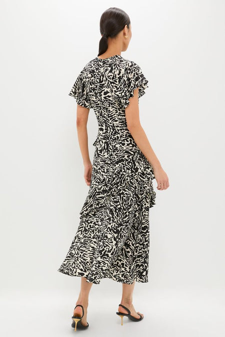 Spotted Jasper Amaia Dress: A classic, high-end midi dress with an effortless abstract print, flutter sleeves, and ruffled skirt, paired with fun strappy heels.