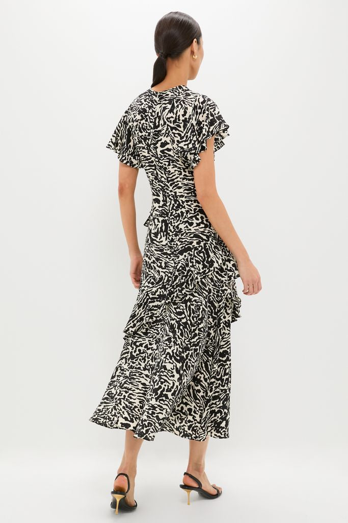 Spotted Jasper Amaia Dress: A classic, high-end midi dress with an effortless abstract print, flutter sleeves, and ruffled skirt, paired with fun strappy heels.
