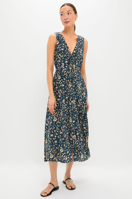 Model in the elegant Midnight Garden Carina Dress, featuring a classic A-line silhouette with a floral print, exuding an effortless, high-end style, paired with fun black flat sandals.