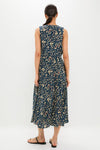 Woman in classic, sleeveless Midnight Garden Carina Dress with leafy floral print, embodying effortless, high-end style. Perfect for fun, casual summer or resort wear.