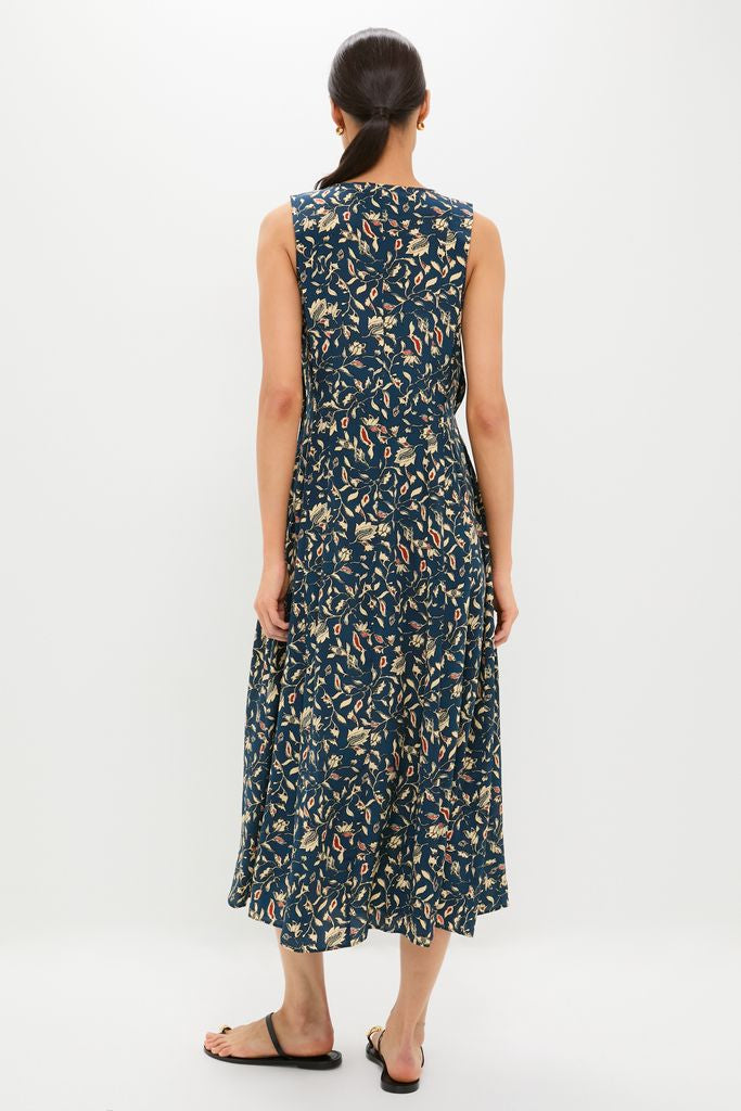 Woman in classic, sleeveless Midnight Garden Carina Dress with leafy floral print, embodying effortless, high-end style. Perfect for fun, casual summer or resort wear.