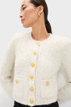 Ivory Una Knit Cardigan with boucle texture and gold-tone buttons, modeled by woman in elegant, classic style—effortlessly blending fun and high-end fashion.