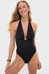Model in classic Noir Milos Maillot swimsuit with a plunging neckline, stone-embellished ring, and open back, exuding an effortless, high-end style. Perfect for fun and confident outings.