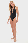 Noir Milos Maillot swimsuit with a classic plunging V-neckline and stone-embellished ring, worn by a woman for an effortless, high-end, and fun style.