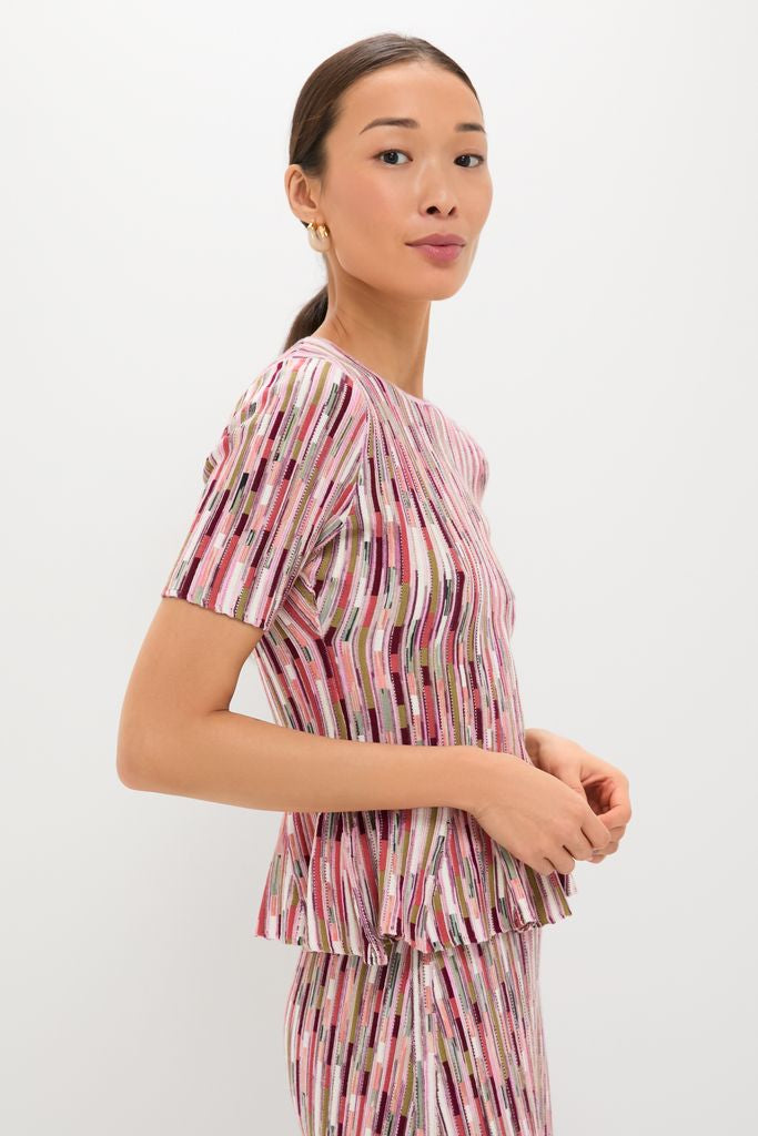 Young woman in profile wearing the Rosewood Samira Pullover, a classic, effortlessly cool ribbed knit top with multicolored vertical stripes, embodying a fun, high-end style.