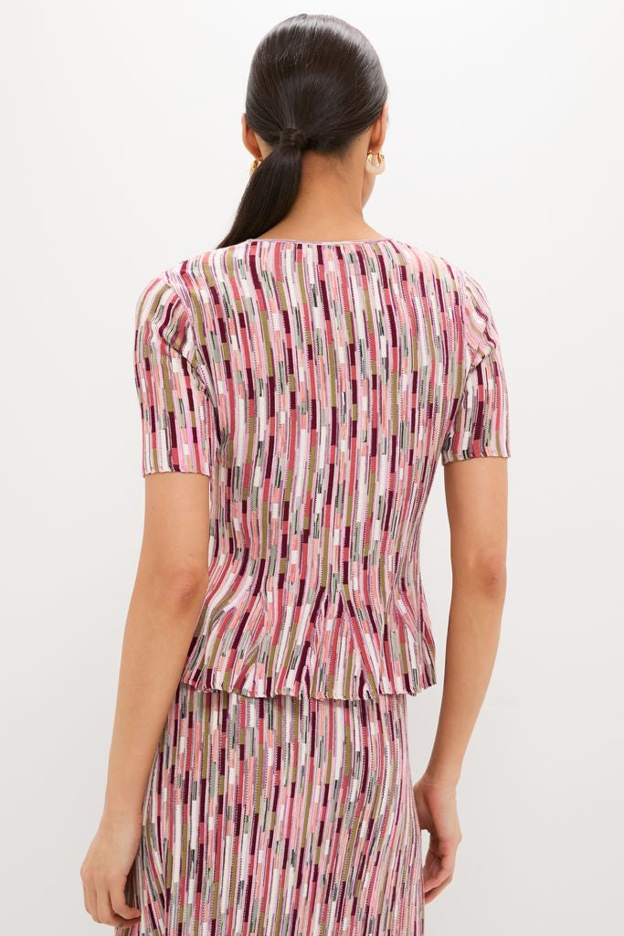 Model in classic Rosewood Samira Pullover, an effortless two-piece knit outfit with a fun peplum top and high-end striped skirt, embodying Tuckernuck's cool style.