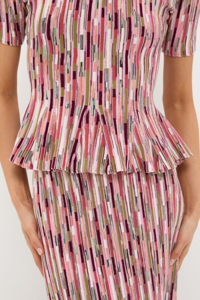 Rosewood Samira Pullover: A classic, high-end knit set with effortless style, featuring a fitted bodice and peplum flare, capturing Tuckernuck's fun and confident aesthetic.