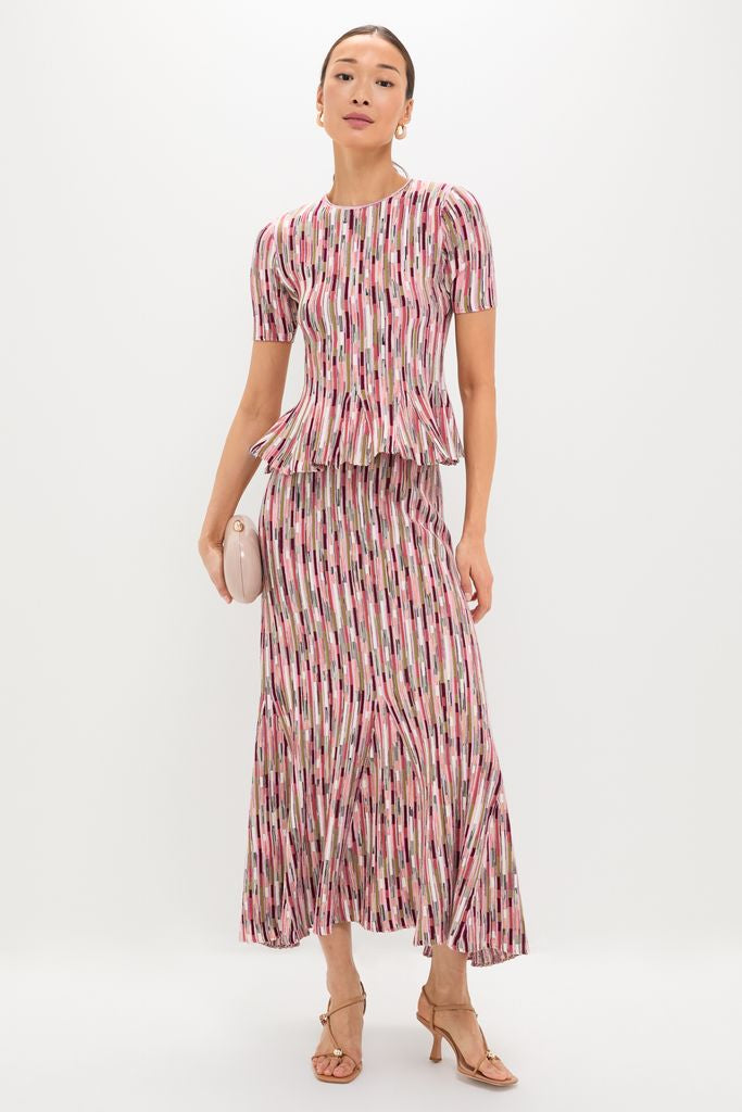 Rosewood Samira Pullover: A classic, effortlessly stylish two-piece with a peplum top and flared skirt, paired with a light-pink clutch and neutral sandals for a high-end look.