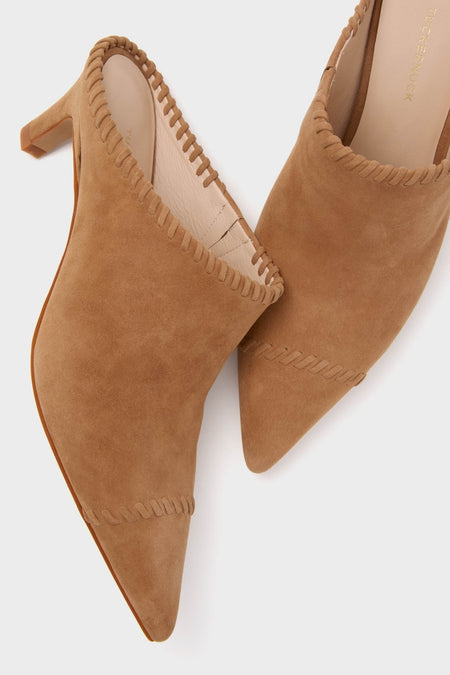 Camel Suede Whipstitch Kathryn Mules, classic and effortless, feature a pointed toe, block heel, and decorative whip-stitch trim, embodying Tuckernuck’s fun and high-end style.