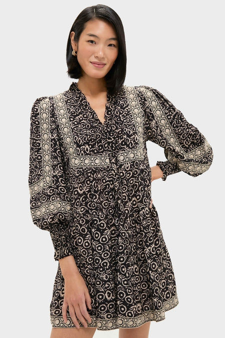 Model wearing the classic Multi Emmeline Print Long Sleeve Mini Tiered Dress, showcasing an effortless, high-end style with fun abstract floral patterns and slightly puffed sleeves.