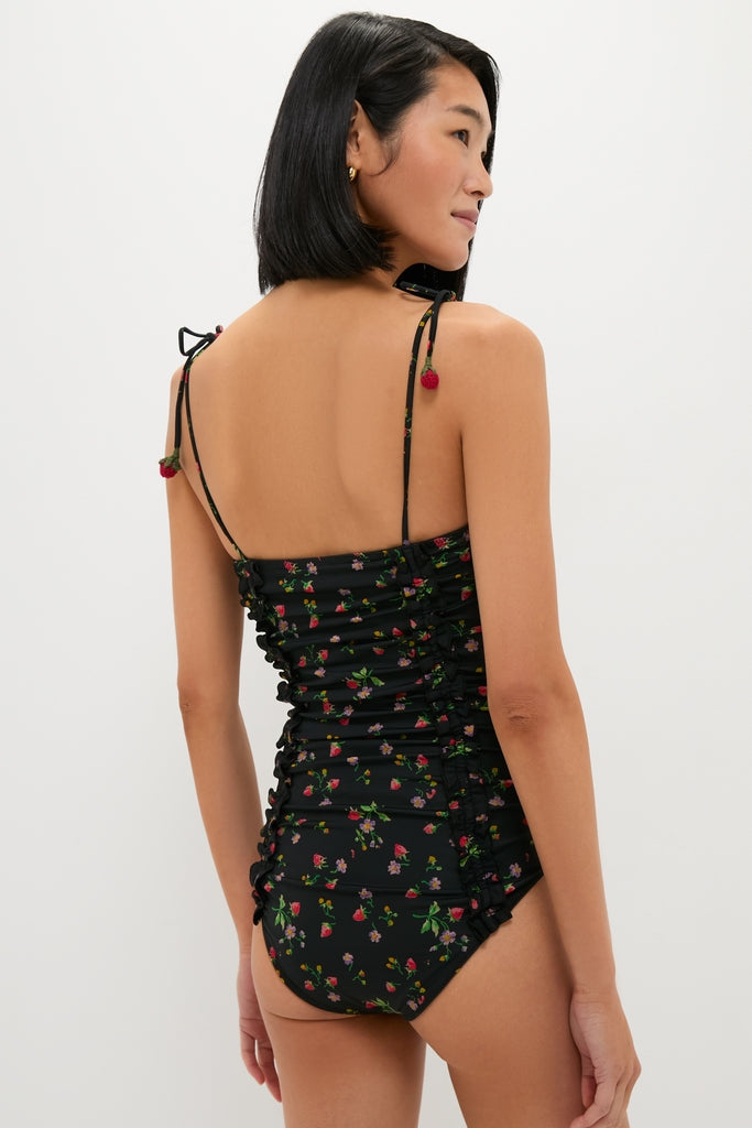 Woman in classic, high-end Multi Katarina Print Tie Strap One Piece swimsuit with floral print, adjustable straps, and ruched detailing, embodying an effortless, fun resort-ready style.