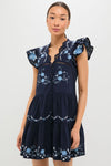 Exclusive Navy Edwina Embroidery Tunic Dress with classic flutter sleeves, intricate floral cross-stitch details, and a tiered silhouette, embodying effortless, high-end style.