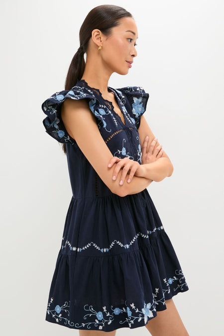 Exclusive Navy Edwina Embroidery Tunic Dress with classic ruffled sleeves, effortless floral embroidery, and a fun, high-end tiered design, perfect for chic styling.