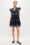 Exclusive Navy Edwina Embroidery Tunic Dress modeled with elegance, featuring classic floral embroidery, effortless tiered design, and fun flutter sleeves for a high-end, feminine look.