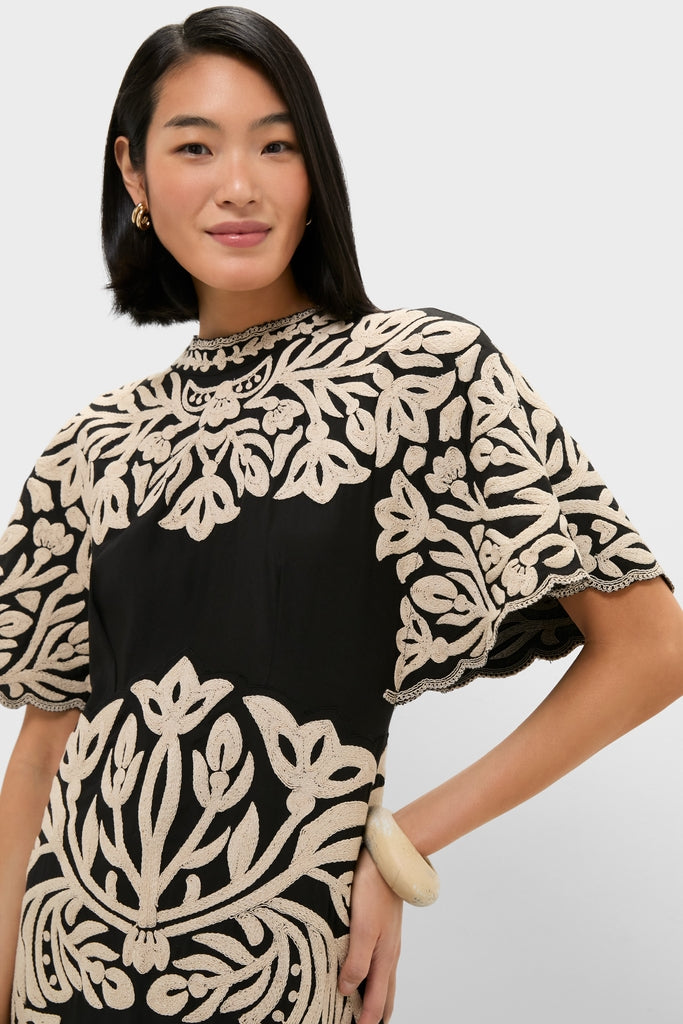 Model wearing the Black Alexandra Embroidery Short Sleeve Midi Dress, featuring classic cream leaf embroidery and effortless styling with a high-end, fun, chic appeal.