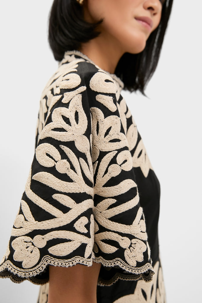 Black Alexandra Embroidery Short Sleeve Midi Dress featuring classic, wide fluttery sleeves and intricate cream rope-style floral embroidery, offering an effortless and fun high-end look.