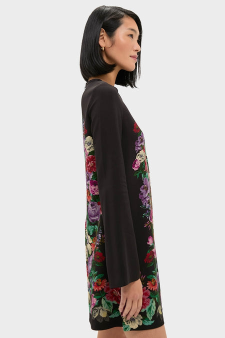 Woman in profile wearing classic Multi Viktoria Print Long Sleeve Mini Dress, featuring an effortless, high-end floral motif for a fun, stylish look.