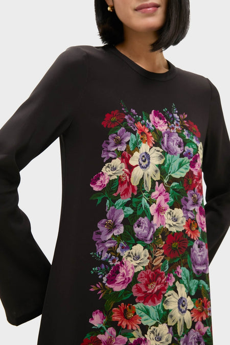 Model wearing the Multi Viktoria Print Long Sleeve Mini Dress, featuring an effortless, fun, and classic high-end floral design, accessorized with gold hoop earrings, embodying Tuckernuck's chic style.