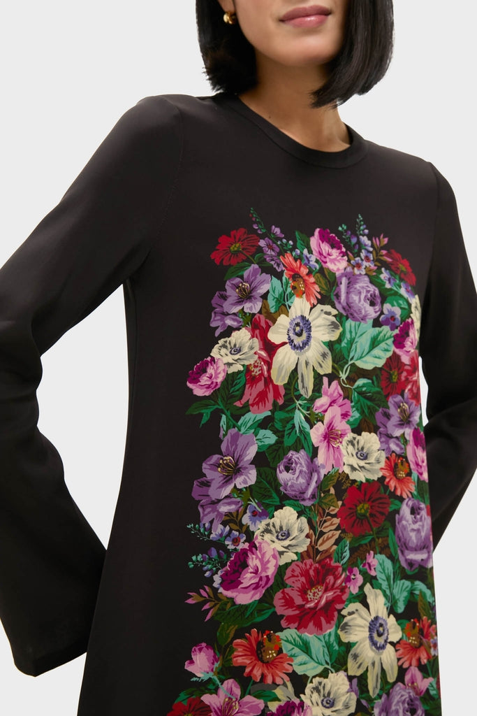 Model wearing the Multi Viktoria Print Long Sleeve Mini Dress, featuring an effortless, fun, and classic high-end floral design, accessorized with gold hoop earrings, embodying Tuckernuck's chic style.