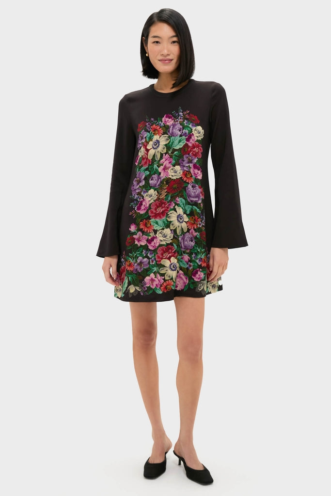 Model wearing the Multi Viktoria Print Long Sleeve Mini Dress, a classic and high-end piece with an effortless, fun multicolored floral design, paired with black heeled shoes.