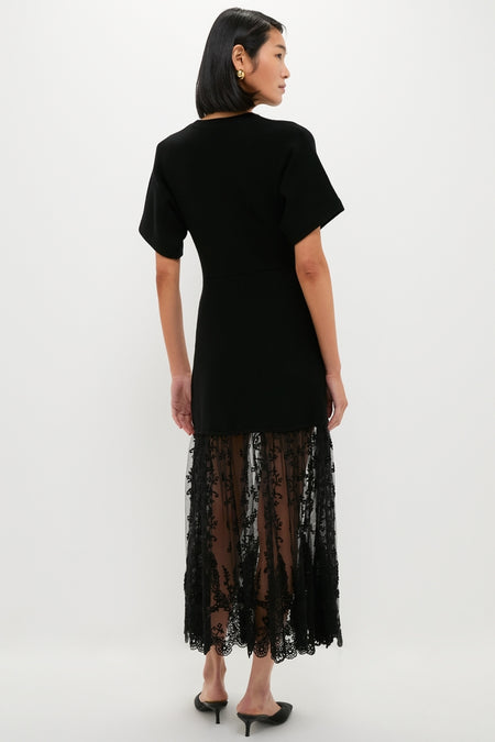 Model wearing the Black Diane Knit Lace Combo Knit Dress, featuring a classic, effortless design with a sheer lace panel and high-end, fun styling.