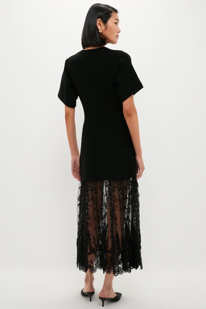 Model wearing the Black Diane Knit Lace Combo Knit Dress, featuring a classic, effortless design with a sheer lace panel and high-end, fun styling.