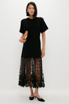 Black Diane Knit Lace Combo Knit Dress: A classic, effortless look featuring a short-sleeved tunic top and semi-sheer lace skirt, paired with black mules, exuding high-end, fun sophistication.