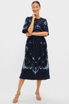 Exclusive Navy Edwina Embroidery Midi Dress featuring classic floral embroidery, effortless lace inserts, and fun bell sleeves, embodying Tuckernuck's cool, high-end style for any occasion.