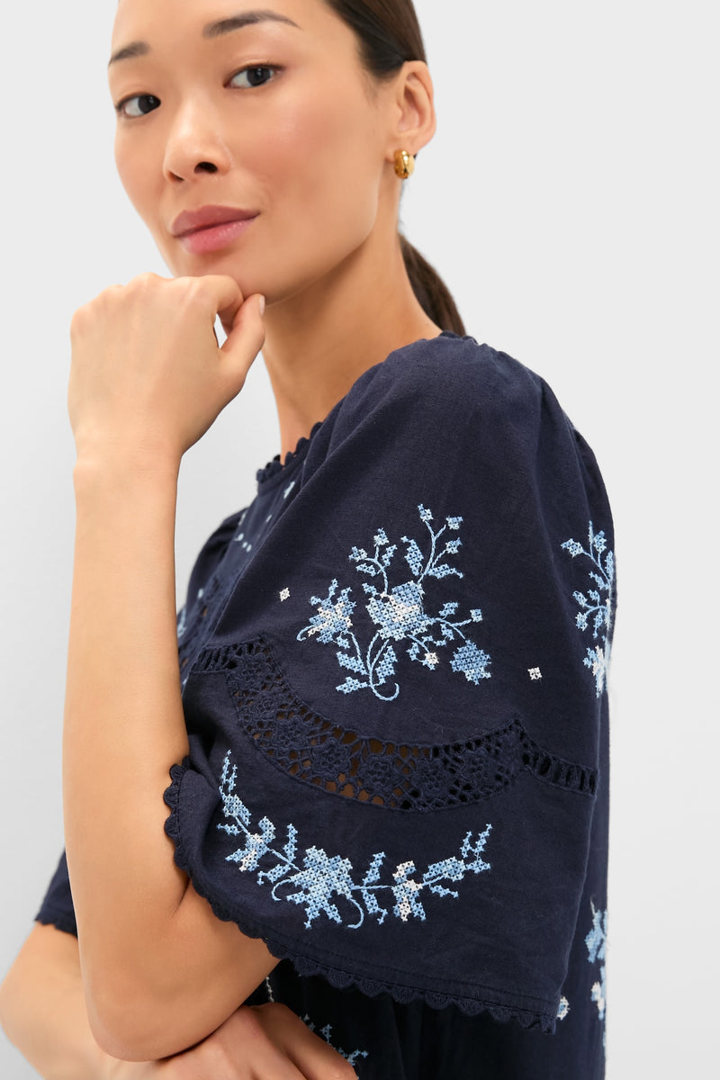 Exclusive Navy Edwina Embroidery Midi Dress features classic floral embroidery, effortless lace detailing, and fun bell sleeves, embodying a high-end, romantic style for any occasion.
