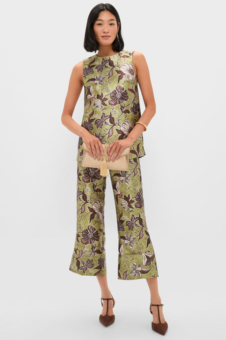 Model wearing a floral green ensemble, holding a beige clutch, accessorized with classic Brushed Brass Vera Earrings, embodying effortless, high-end style for a fun, confident look.