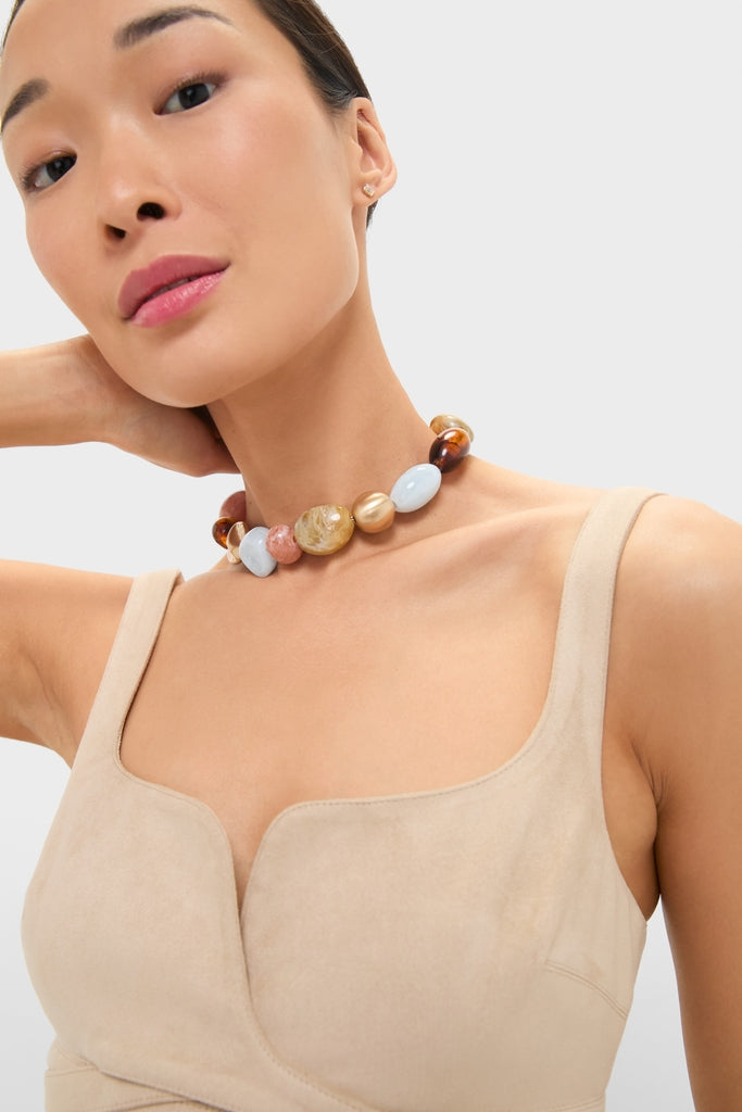 Woman wearing the Saddle Bauble Multi Mercier Choker, a classic and high-end necklace with large, colorful beads, effortlessly adding fun sophistication to her sleeveless top.