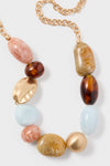 Saddle Bauble Multi Mercier Choker: A classic, high-end statement necklace featuring oversized pastel and tortoiseshell beads on a short gold-tone chain for an effortless, fun look.