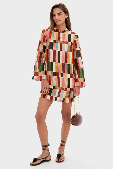 Woman holding the classic, high-end Caramel Tortoise Eviana Clutch, showcasing its pearlized acrylic finish and gold chain strap, embodying effortless sophistication and fun elegance.