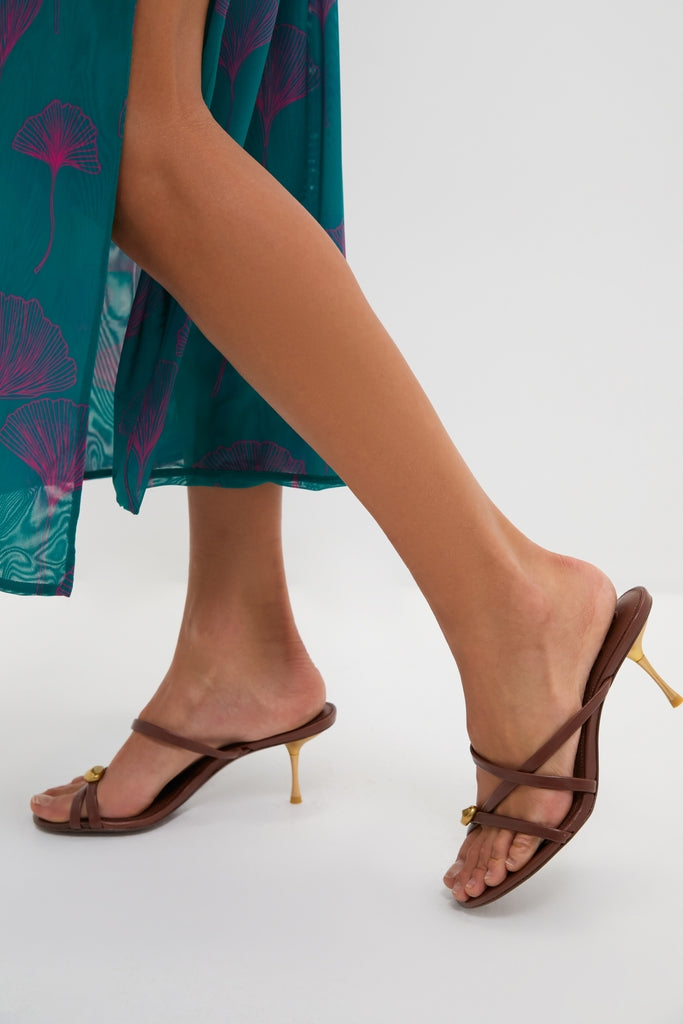 Saddle Valeska Sandals feature classic brown leather straps, a chic gold kitten heel, and an asymmetrical design, offering an effortless, high-end look perfect for any occasion.