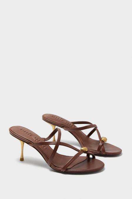 Saddle Valeska Sandals feature classic, effortless brown leather crisscross straps with chic gold accents and a high-end metallic stiletto heel, perfect for fun, versatile styling.