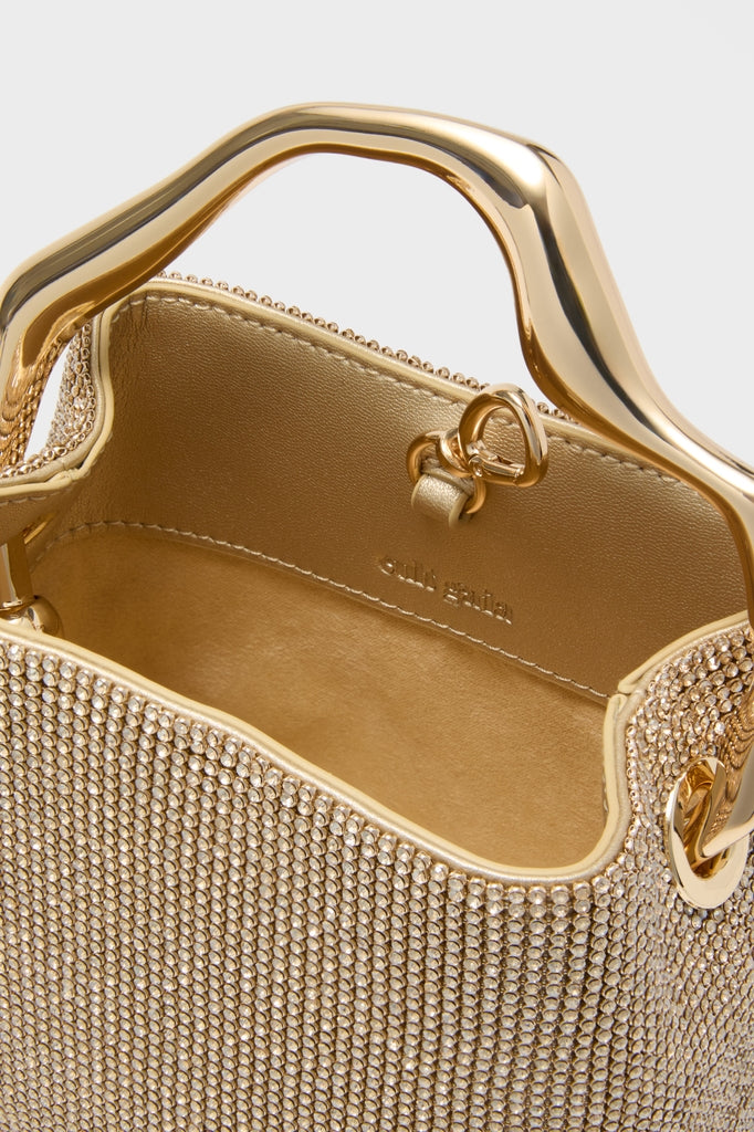 Sand Dollar Solene Mini Top Handle: a classic, high-end evening bag with gold rhinestones and sculptural handle, effortlessly adding fun sparkle to any occasion.