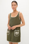 Young woman models the Fern Embroidered Mini Terrycloth Dress Coverup, featuring a classic scooped neckline, fun shell graphics, and effortless style, embodying Tuckernuck's high-end, confident fashion.
