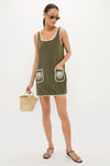 Young woman in a classic, effortless Fern Embroidered Mini Terrycloth Dress Coverup with white accents, holding a fun, high-end straw tote, reflecting Tuckernuck's confident style.