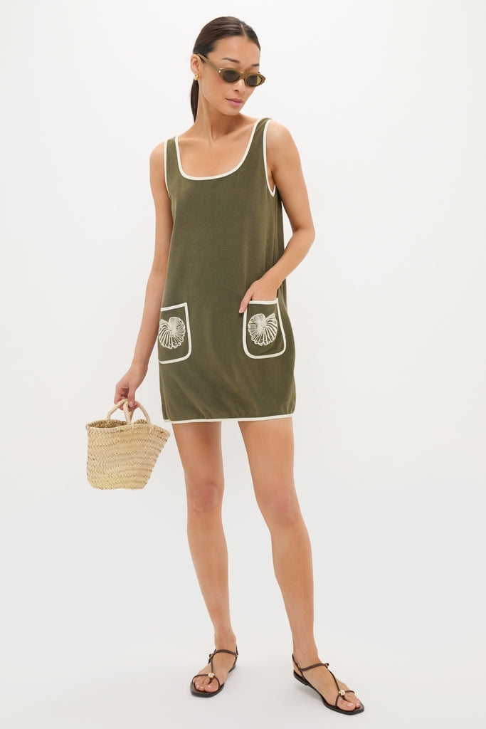 Young woman in a classic, effortless Fern Embroidered Mini Terrycloth Dress Coverup with white accents, holding a fun, high-end straw tote, reflecting Tuckernuck's confident style.