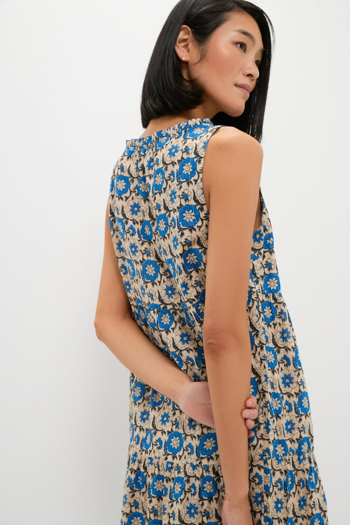 Cobalt Primose Salty Paloma Caftan: a classic, effortless ankle-length dress with blue floral patterns, modeled in profile, exuding a fun and high-end vibe.