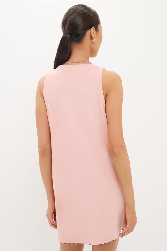 Woman wearing a classic, high-end Coral Embroidered Mini Bermuda Terrycloth Coverup, showcasing an effortless and fun style with clean lines and a simple round neckline.