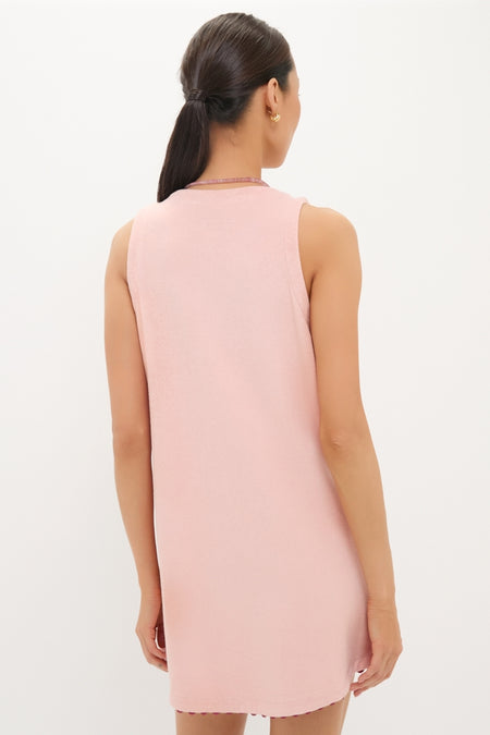 Woman wearing a classic, high-end Coral Embroidered Mini Bermuda Terrycloth Coverup, showcasing an effortless and fun style with clean lines and a simple round neckline.