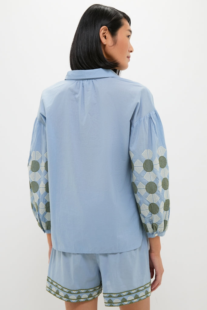 Model wearing the classic Sky Geometric Embroidered Paget Top with voluminous blouson sleeves and matching shorts, showcasing an effortless, high-end summer look for fun destinations.
