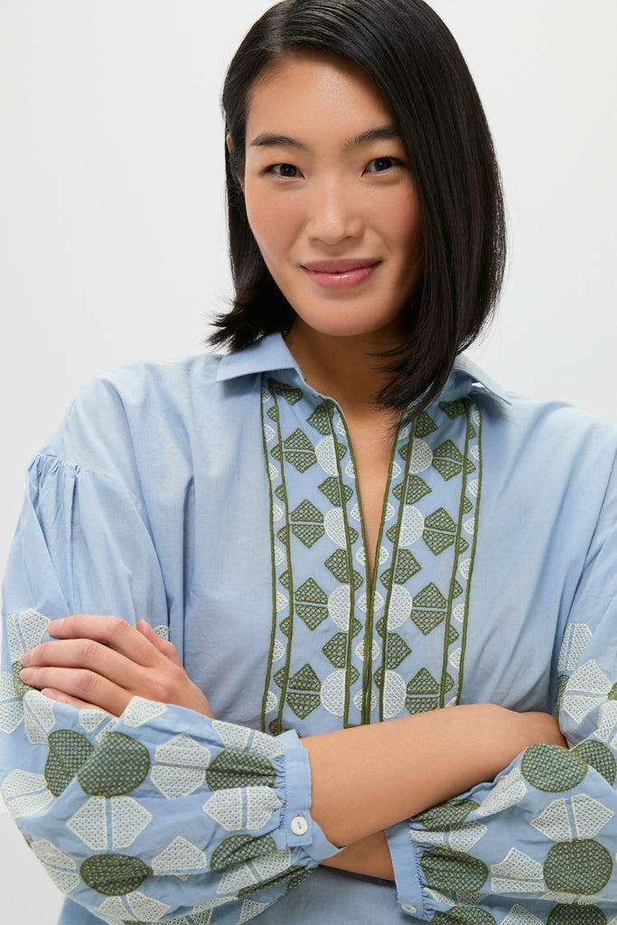 Young woman wearing the Sky Geometric Embroidered Paget Top with classic green-and-white embroidery, exuding an effortless, high-end look. Perfect for fun, warm-weather adventures.