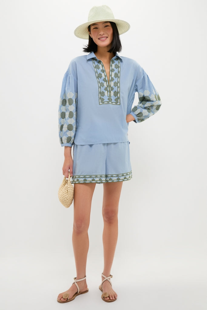 Woman in a classic, effortless Sky Geometric Embroidered Paget Top and matching shorts, holding a woven clutch, embodying Tuckernuck’s high-end, fun summer style.