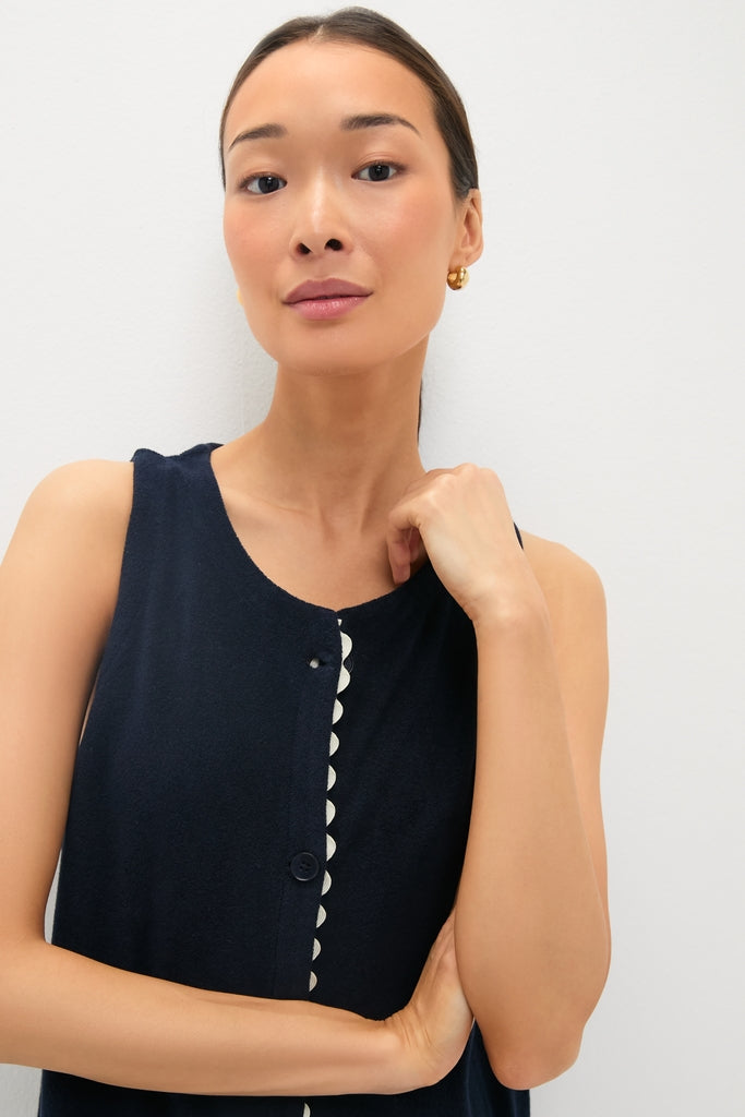 Woman models classic Navy Embroidered Bermuda Terrycloth Caftan with scalloped trim, small gold hoop earrings, embodying effortless, high-end style.